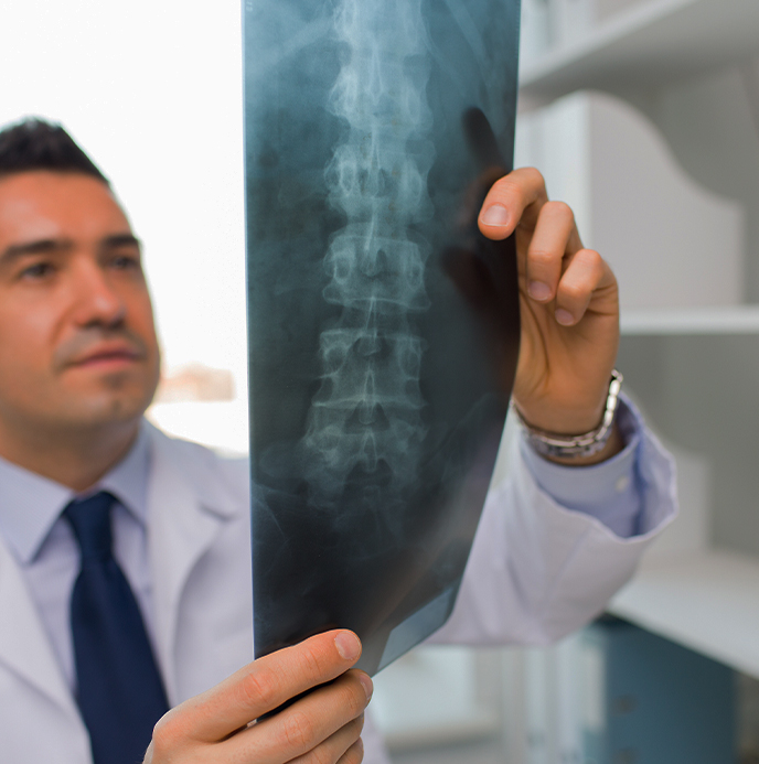 Doctor at Liebman Wellness Center examining patient x-rays for spine injury