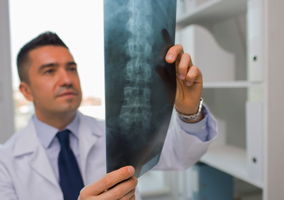 Doctor at Liebman Wellness Center examining patient x-rays for spine injury